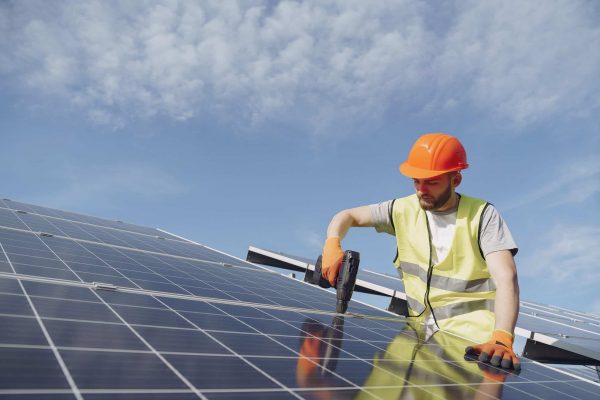 Male,Worker,With,Solar,Batteries.,Man,In,A,Protective,Helmet.