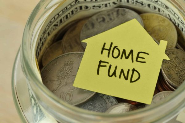 Coins,And,Bills,In,A,Jar,With,Label,Home,Fund