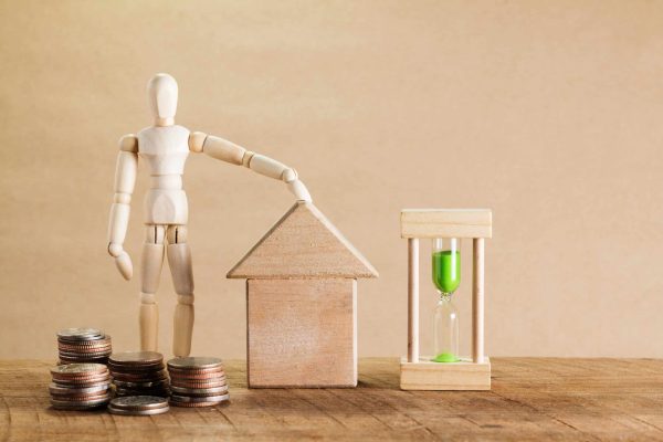 Wooden,Puppet,Rolls,Of,Coins,For,Finance,And,Business,Concept
