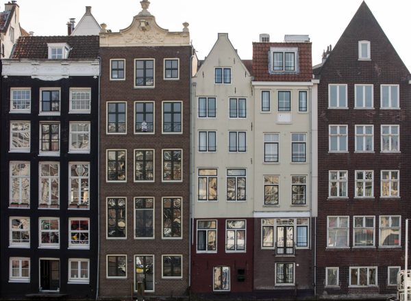 Typical,Gabled,Houses,On,Damrak,Street,In,Amsterdam,,Holland,,Netherlands