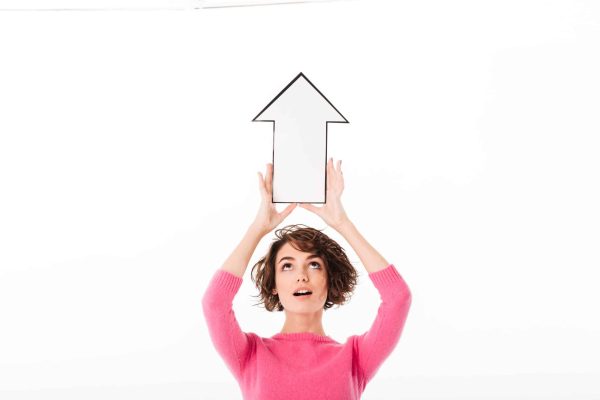 Portrait,Of,A,Cheerful,Pretty,Girl,Pointing,Up,With,A